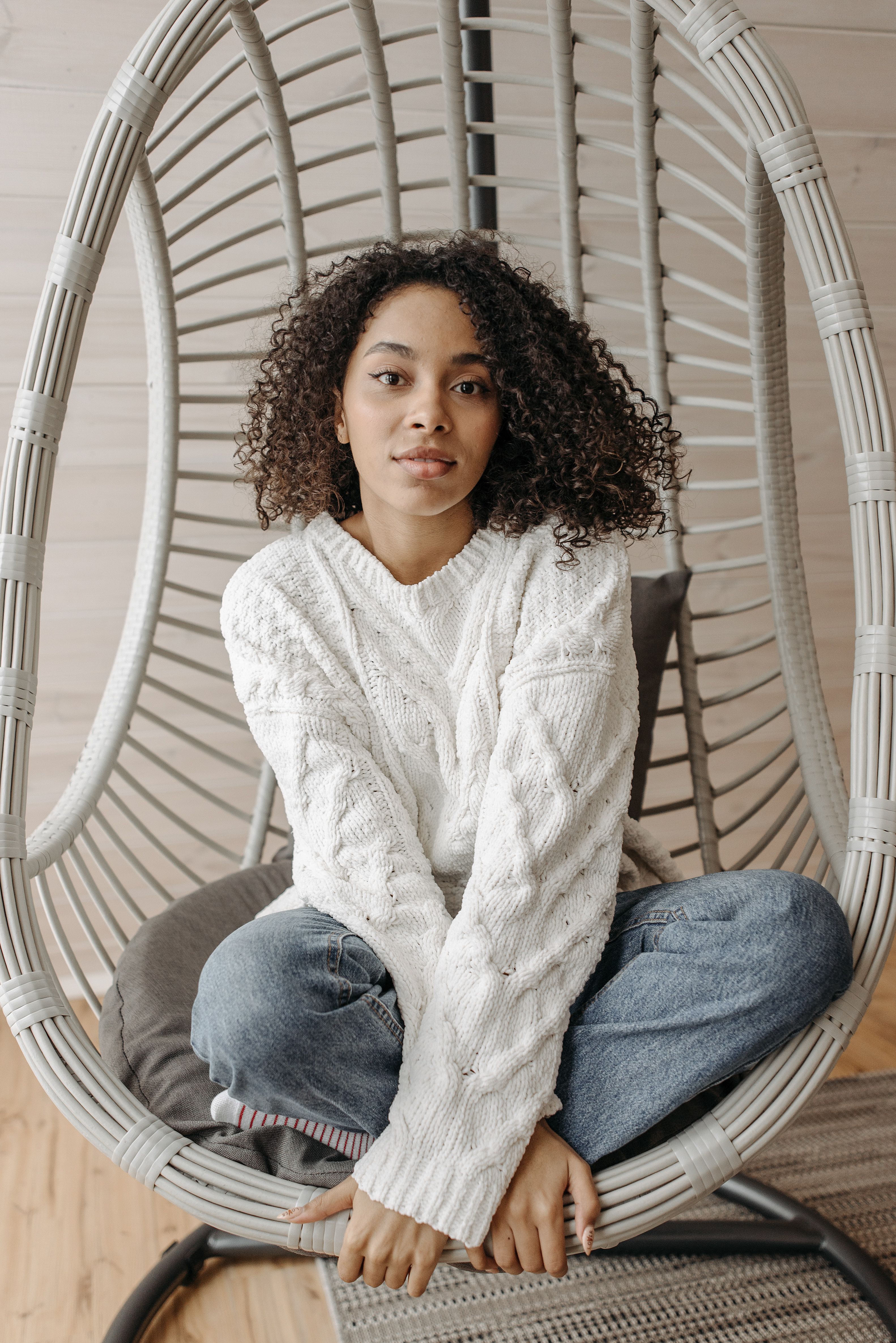 Woman in a Knitted Sweater Sitting on a Chair · Free Stock Photo