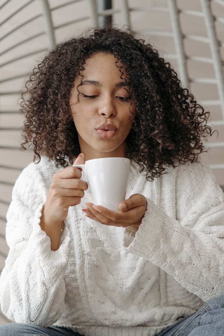 Woman Blowing A Hot Beverage 