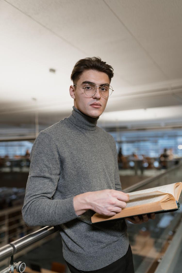 A Man Holding A Book 