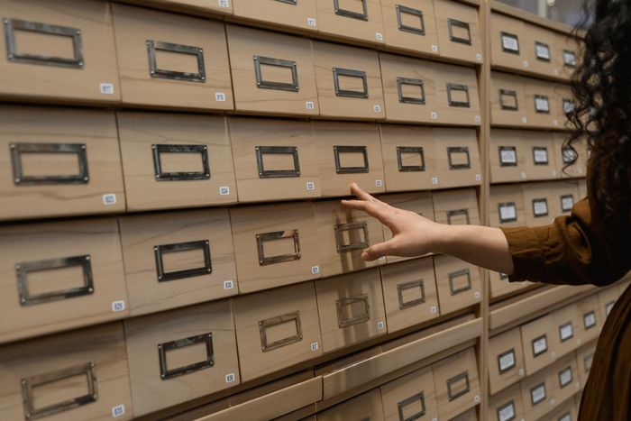Archival storage boxes on shelving with label holders