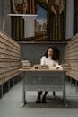 Woman studying at a Table with Books