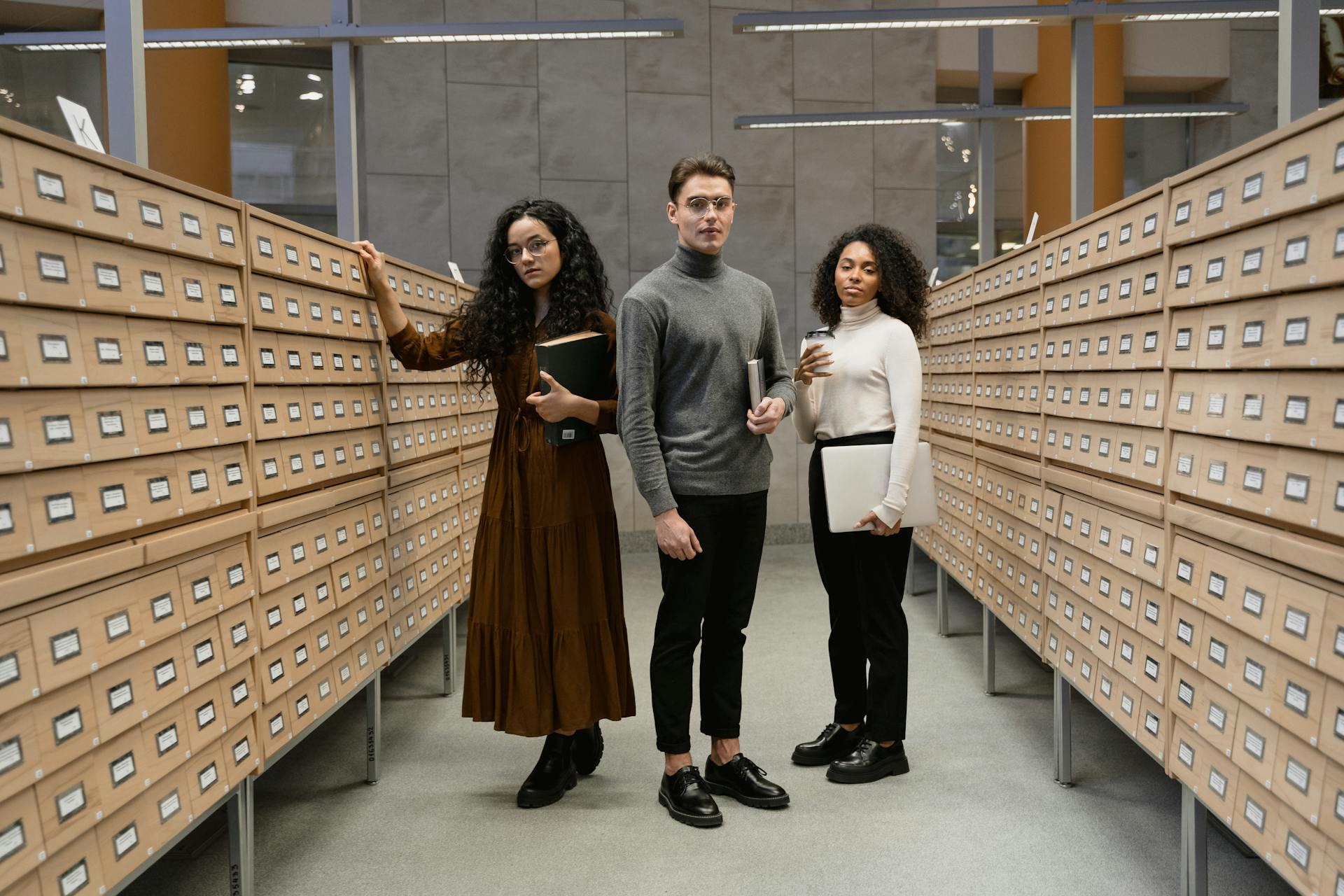 College Students standing between Archive Drawers