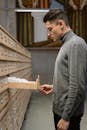 A Man in a Turtleneck Opening a Drawer