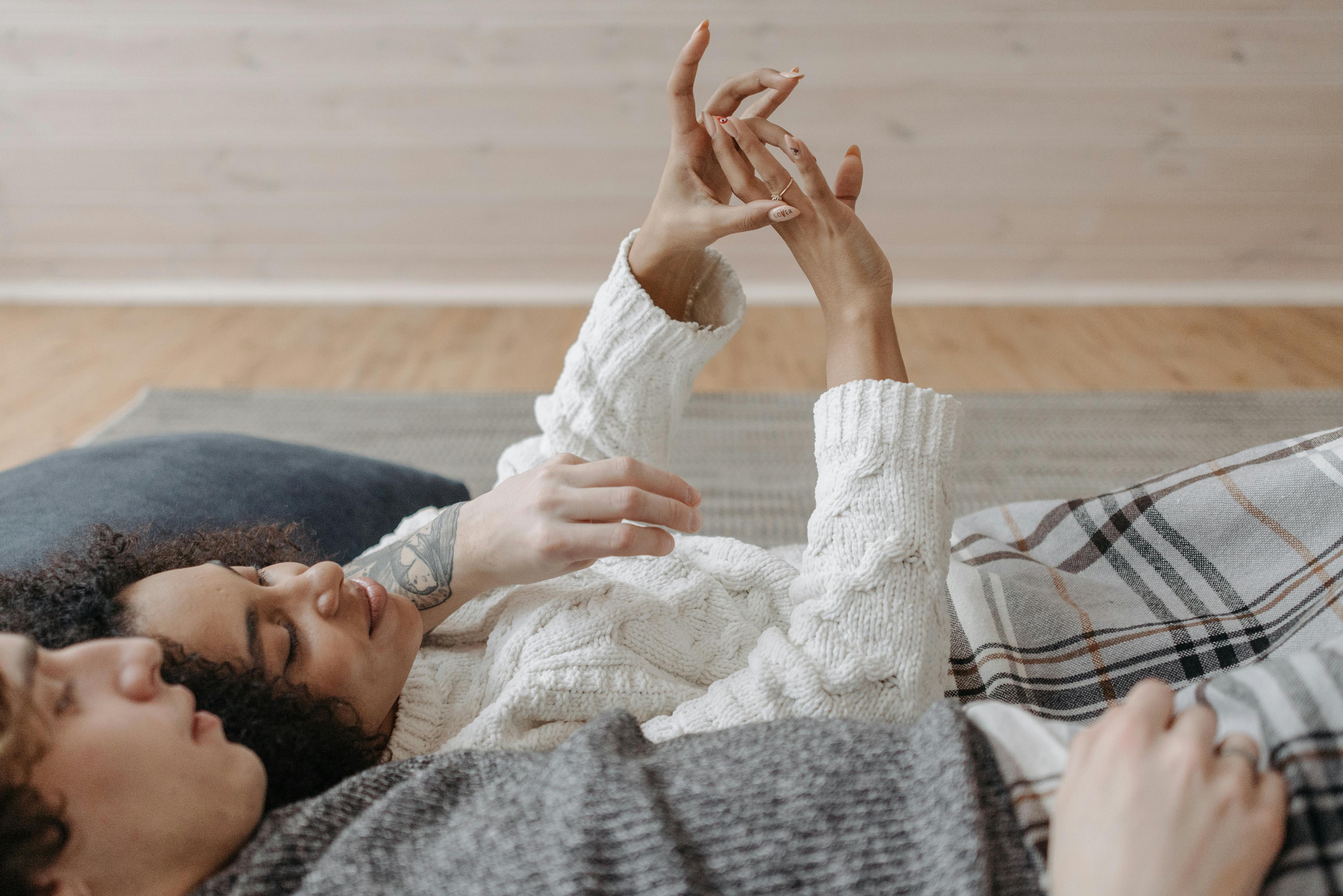 couple looking at engagement ring - how much is a 2ct diamond