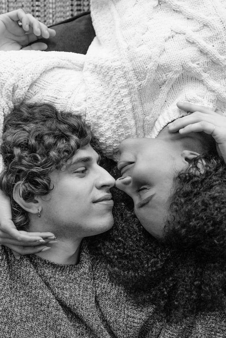 Black And White Photography Of A Couple Lying On The Floor While Looking At Each Other