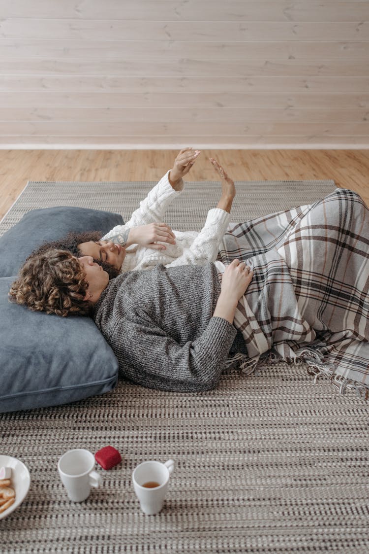 A Sweet Couple Lying On The Floor 