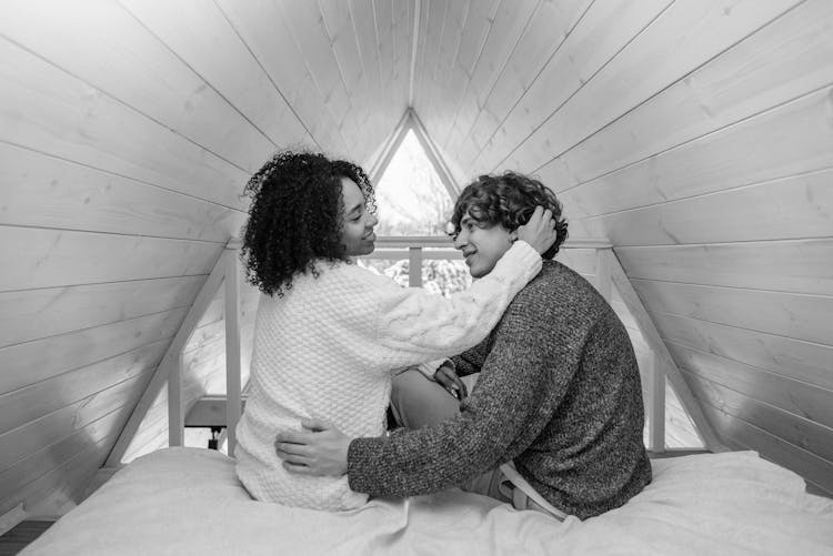 Monochrome Shot Of A Happy Couple Smiling At Each Other