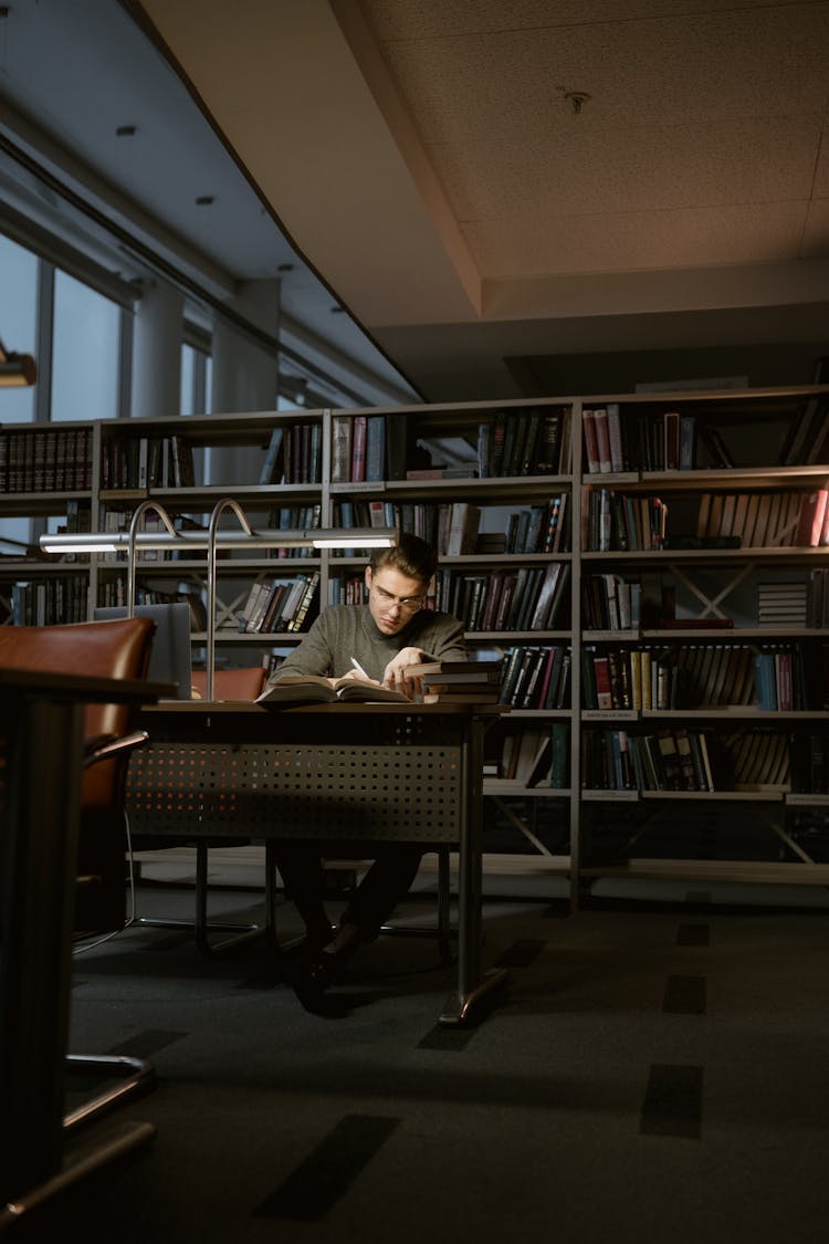 A Man Researching Alone At The Library