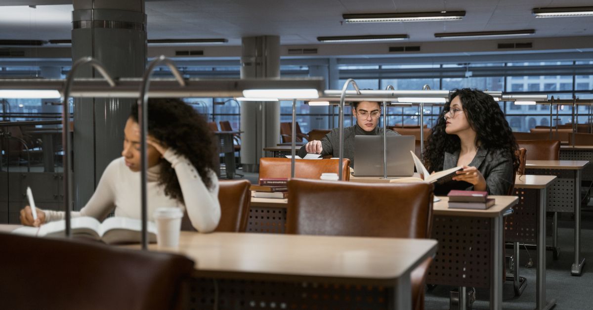 Gen Z students studying together in a bright modern public library