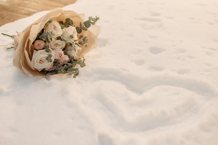 Bouquet Of Flowers On Top Of Snow