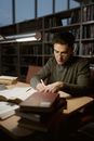 Man in Gray Sweater Reading Book