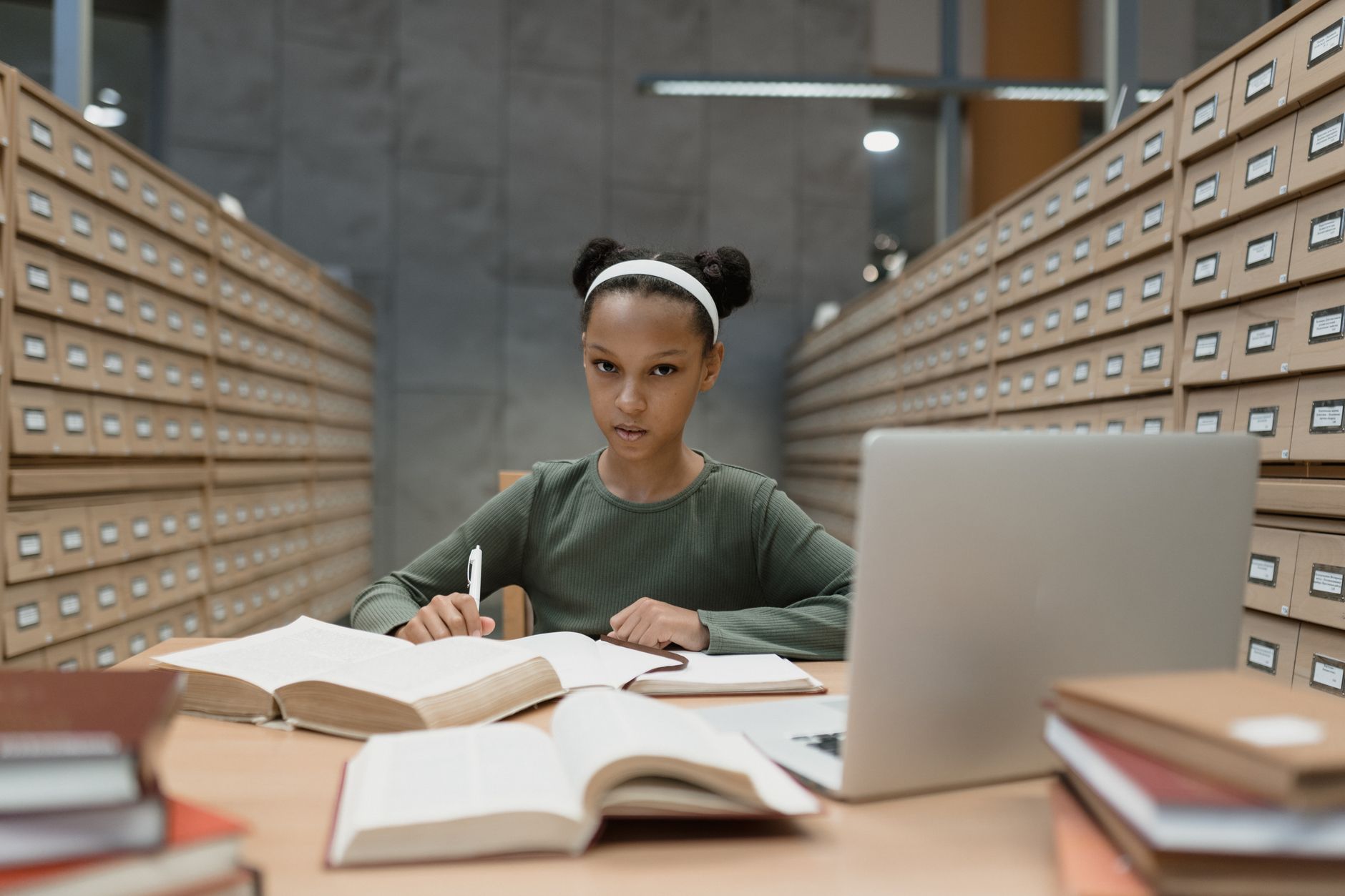 International student researching university requirements in a modern library