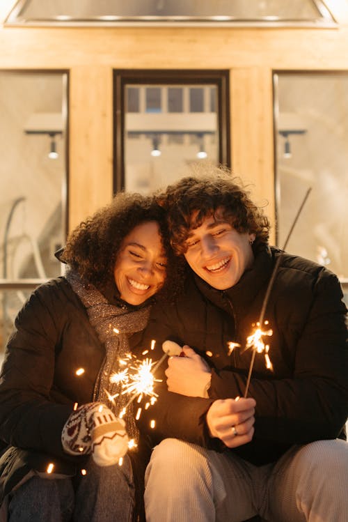 Smiling Couple Holding Sparklers