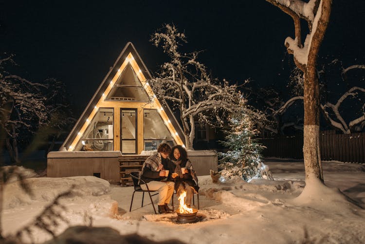 A Romantic Couple Sitting Outside At Night