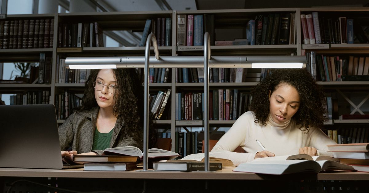 library reading room with people working and reading