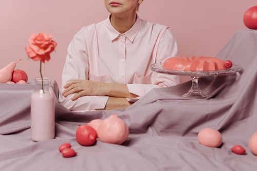 Free Stylish pink-themed concept with a woman, fruits, and roses in a harmonious setting. Stock Photo