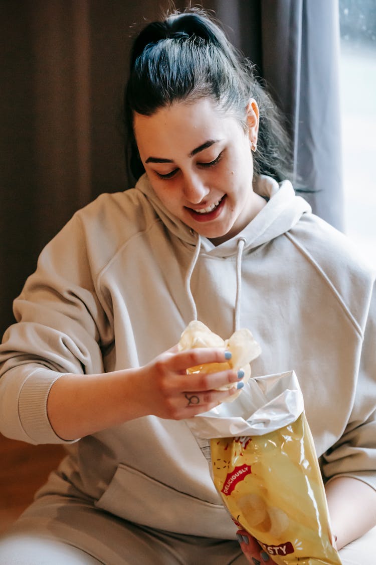 Content Woman Eating Tasty Potato Chips