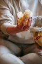 Crop unrecognizable plump woman demonstrating crispy chips in hand