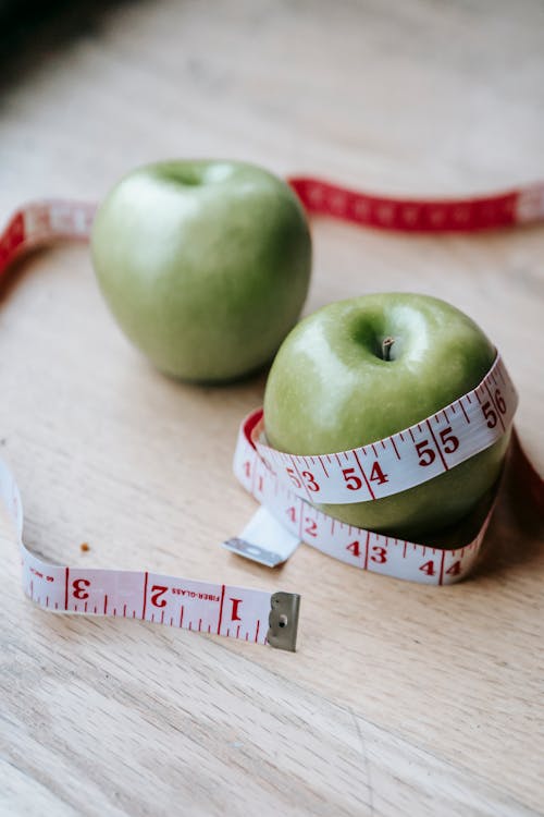 Free Measuring Tape wrapped Around an Apple Stock Photo