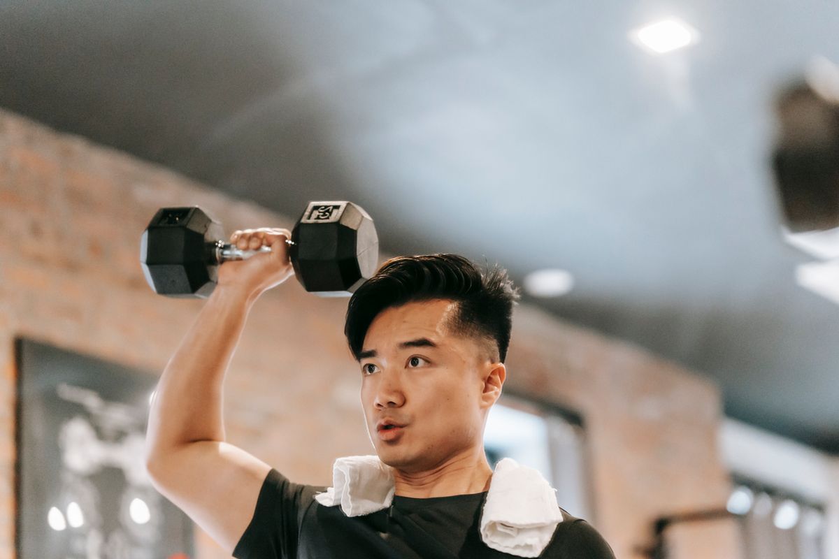 Woman over 50 lifting dumbbells with calm, controlled form