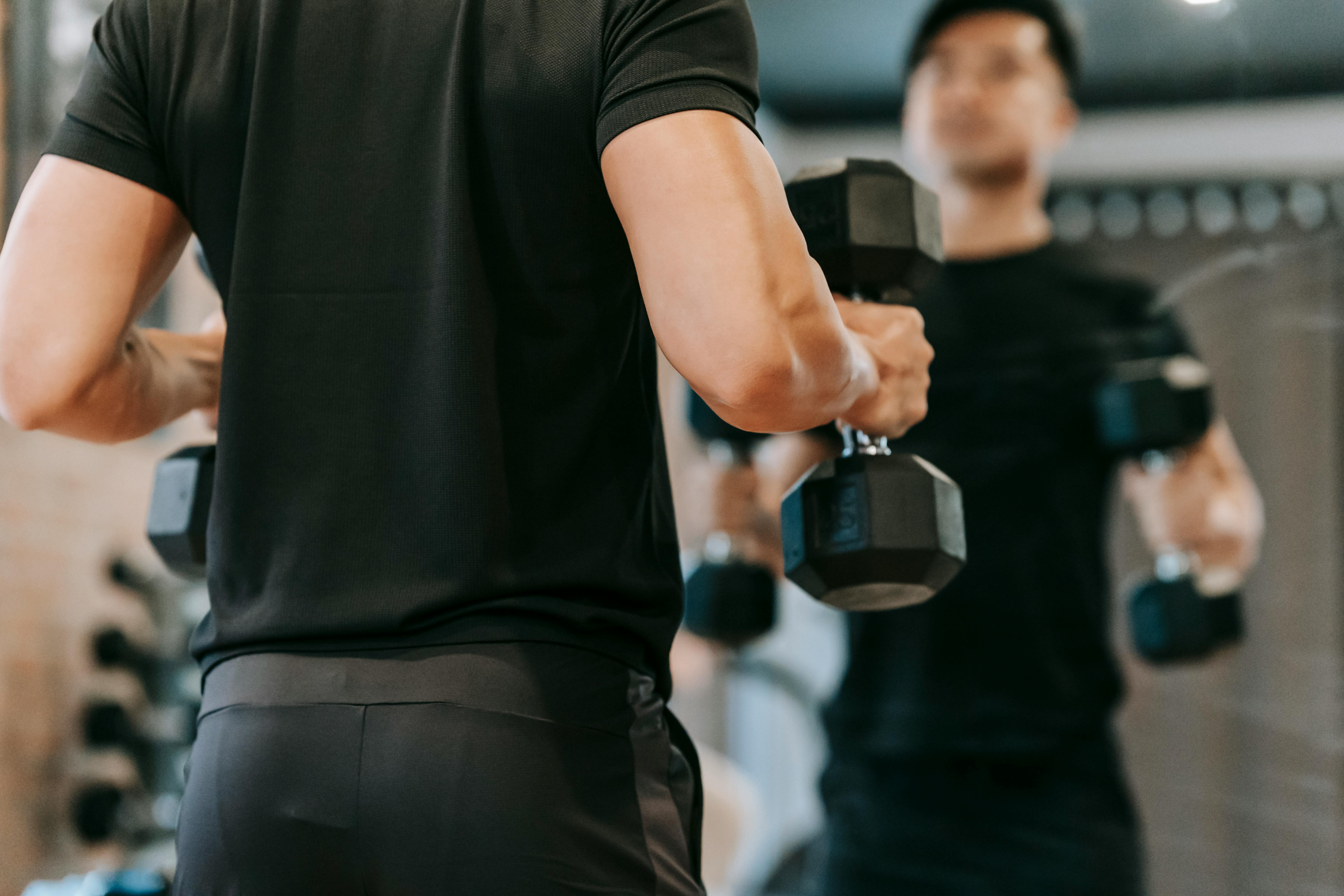 Muscular Asian man pumping bicep · Free Stock Photo