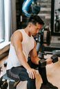 Strong Asian man lifting dumbbell