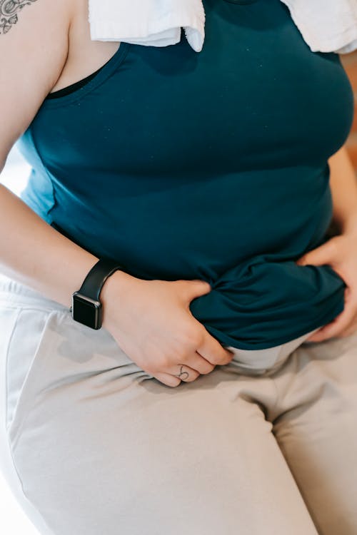 A woman holding fold on belly