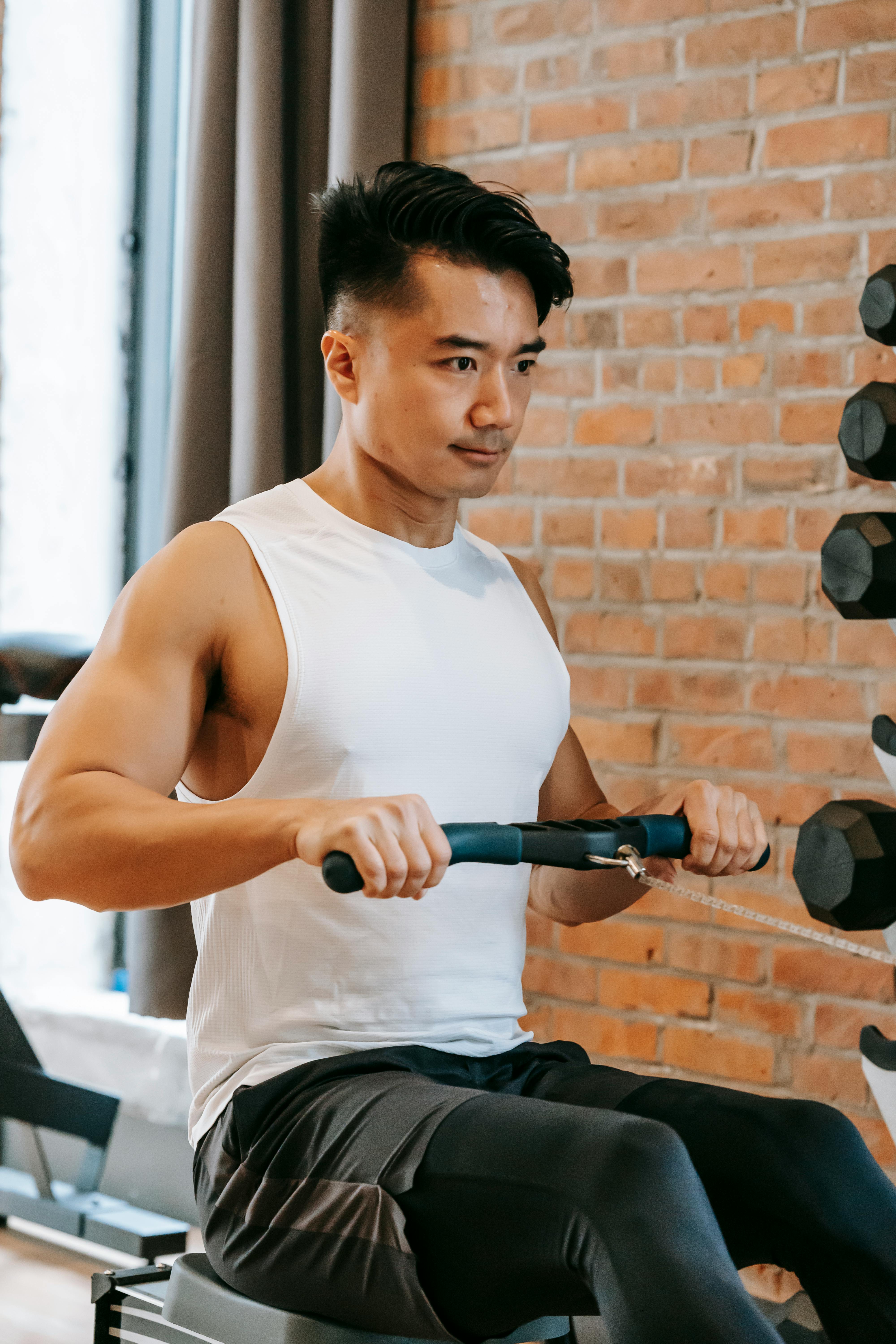 asian man working out with gym equipment