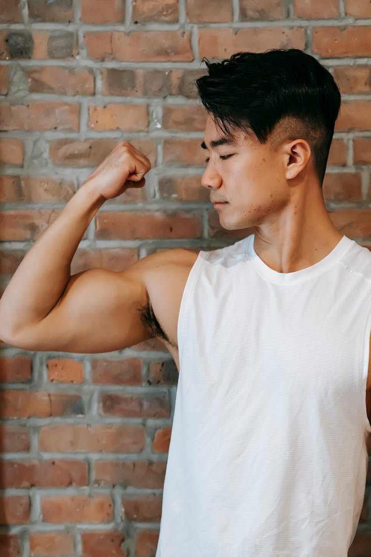 Young Asian Man Flexing Bicep Musclearm