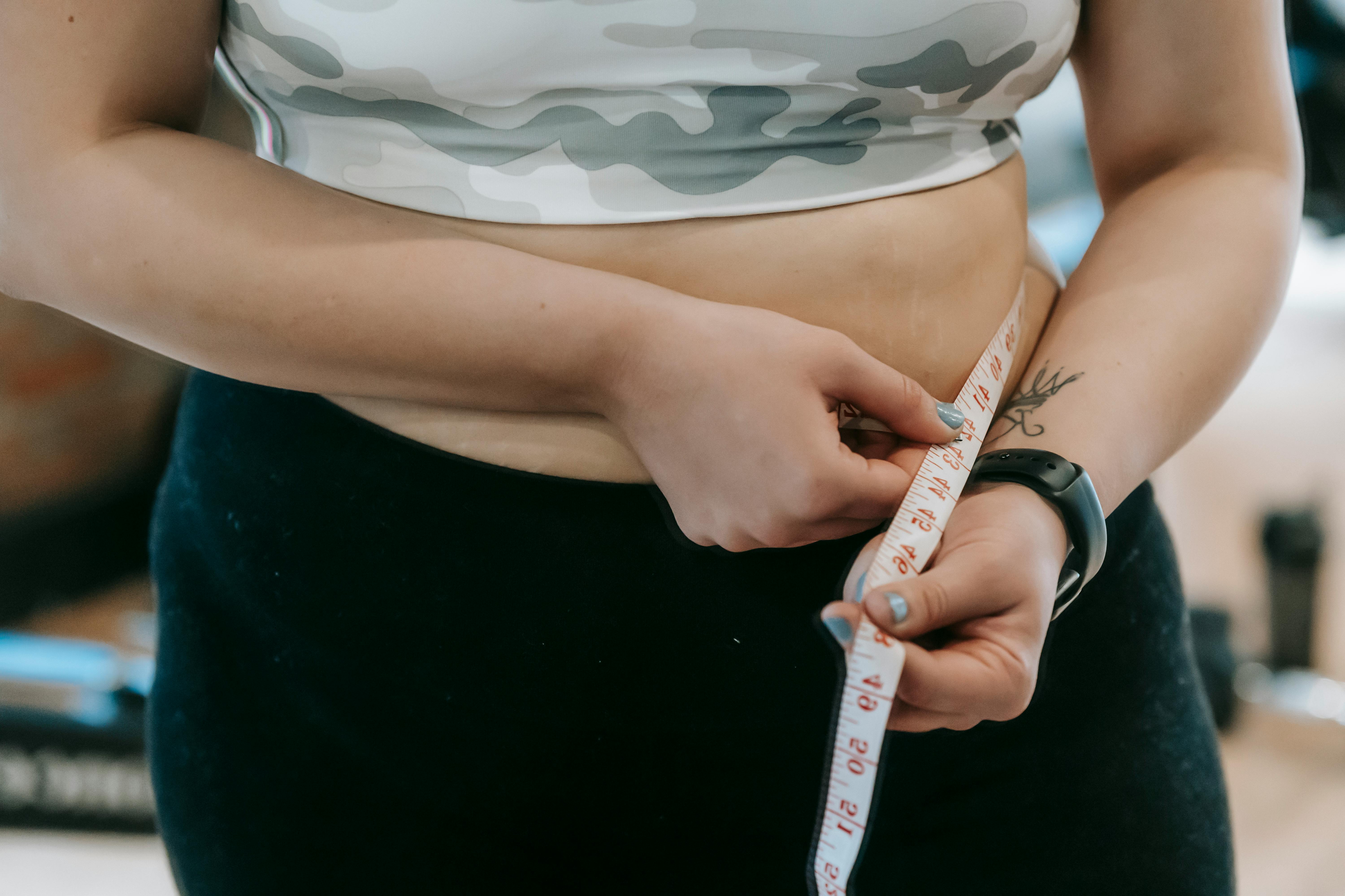 Unrecognizable Girl Measures Her Nude Breast Measuring Tape. Stock