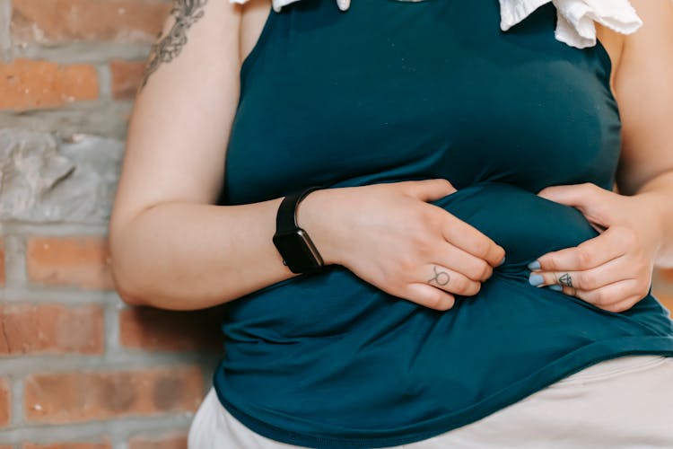 A Woman Holding Fold On Her Belly