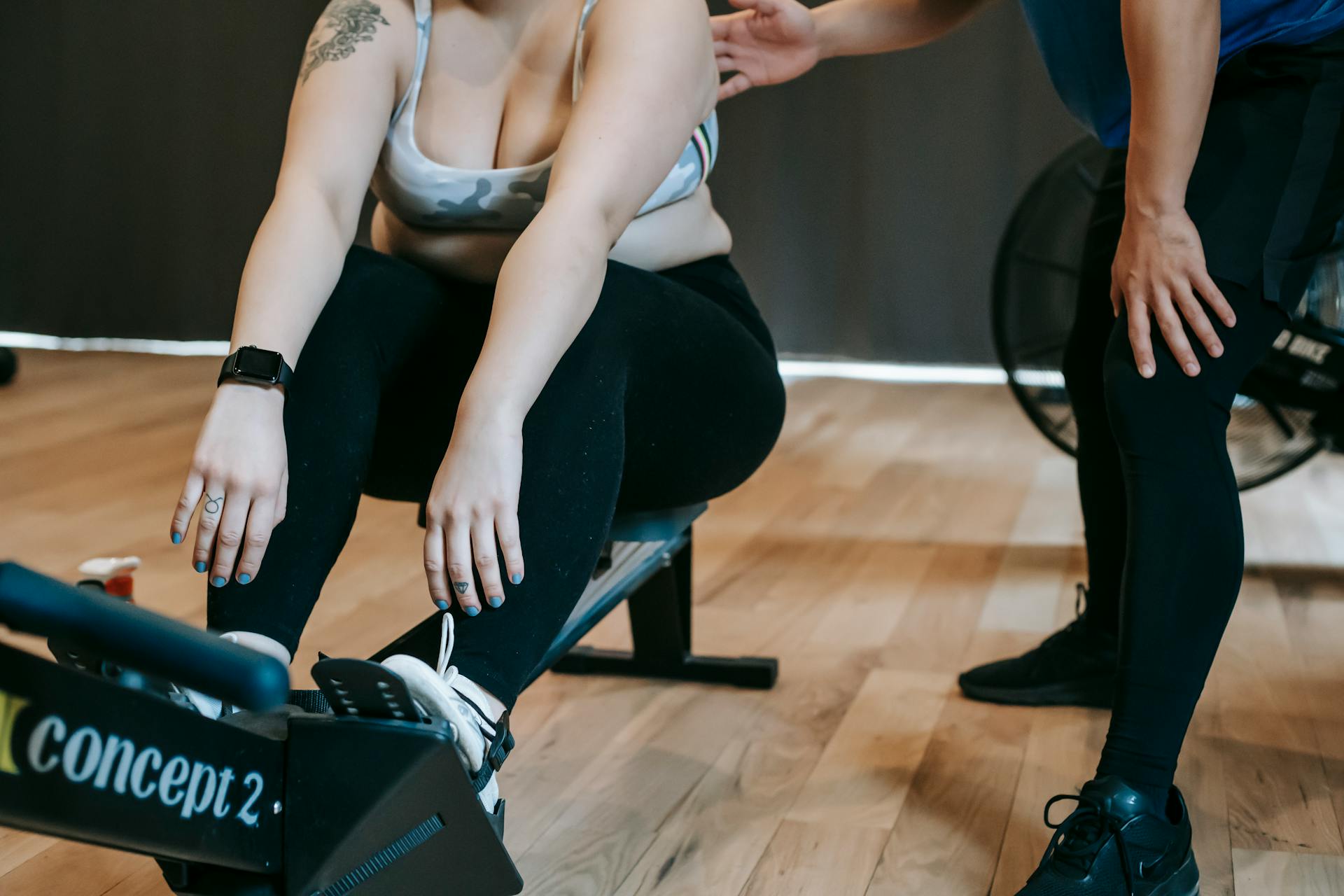 Trainer instructing plus size woman doing exercises