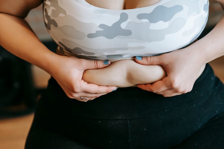 Anonymous Obese Lady Touching Stomach In Gym Before Workout