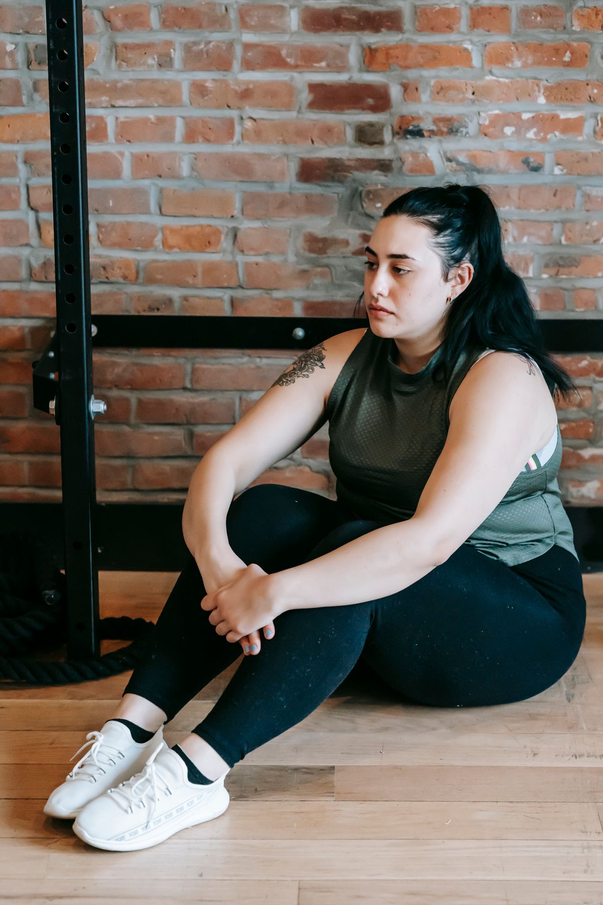 Woman resting on the gym floor after a workout