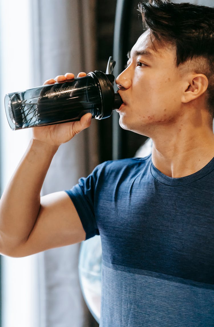 Asian Sportsman Drinking Water From Bottle