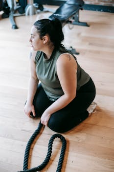 Young woman in sportswear taking a break during a gym workout session.