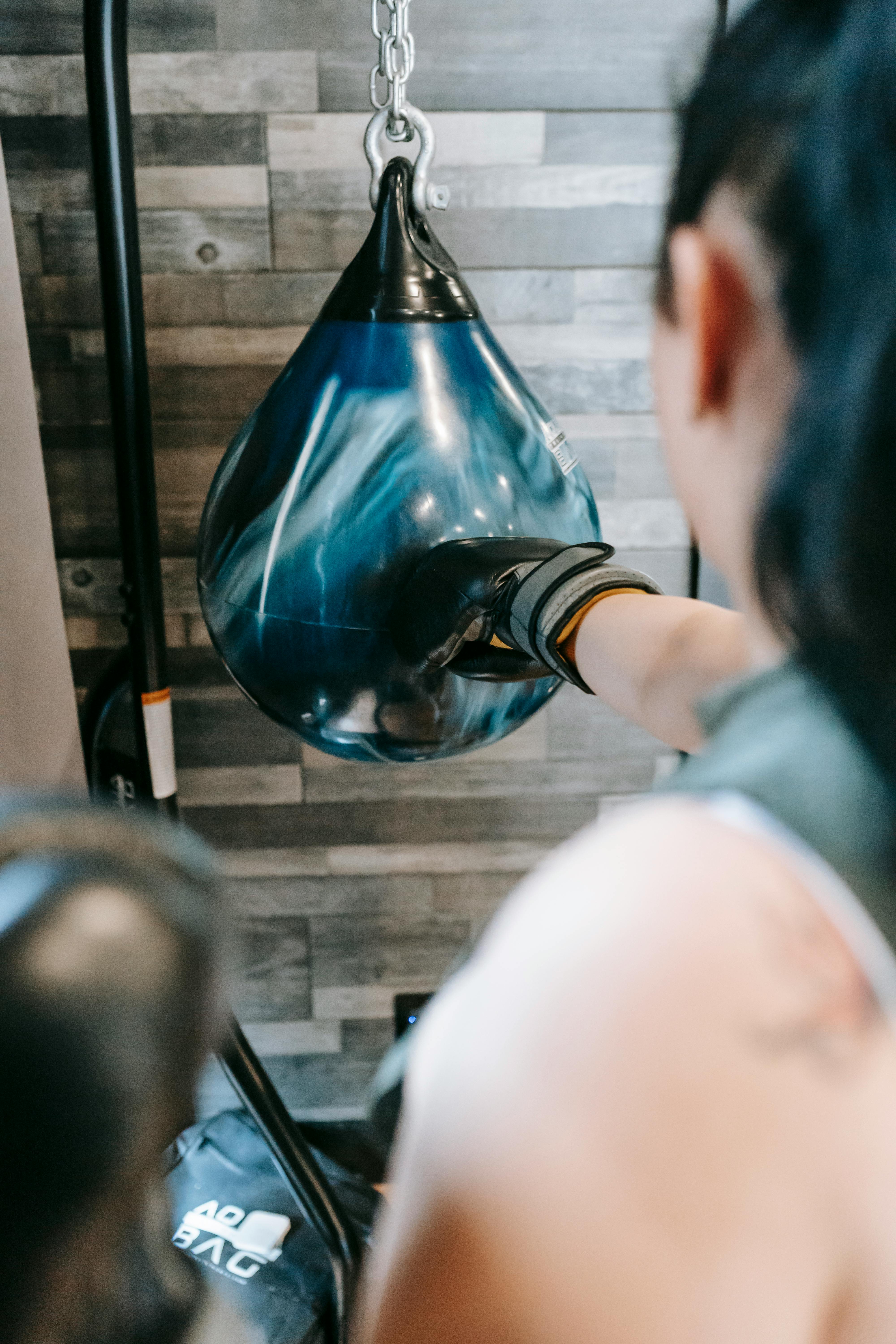 female practicing bunch in boxing club