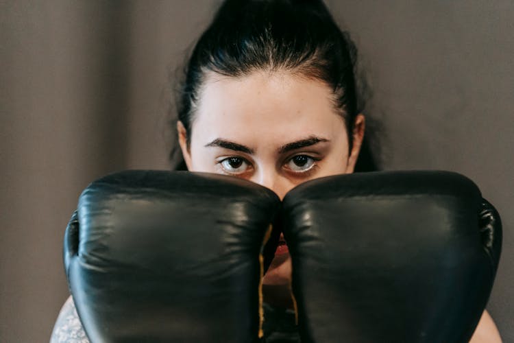 Serious Young Sportswoman Standing In Boxing Defensive Stance