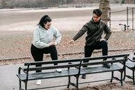 Asian trainer teaching woman doing sports exercise in park