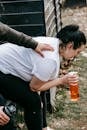 Serious young overweight woman drinking water after workout with trainer