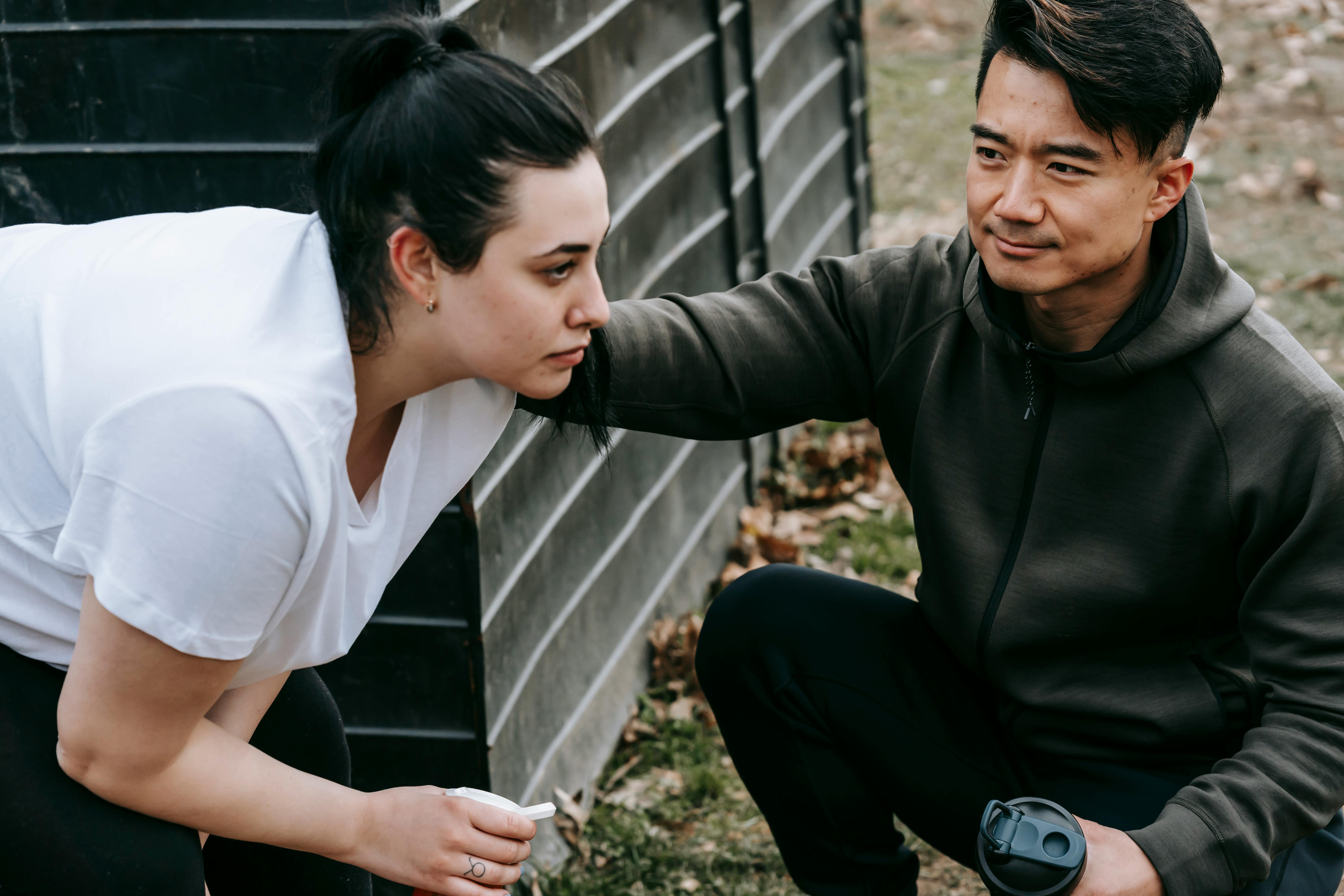 asian young coach helping a woman doing exercises