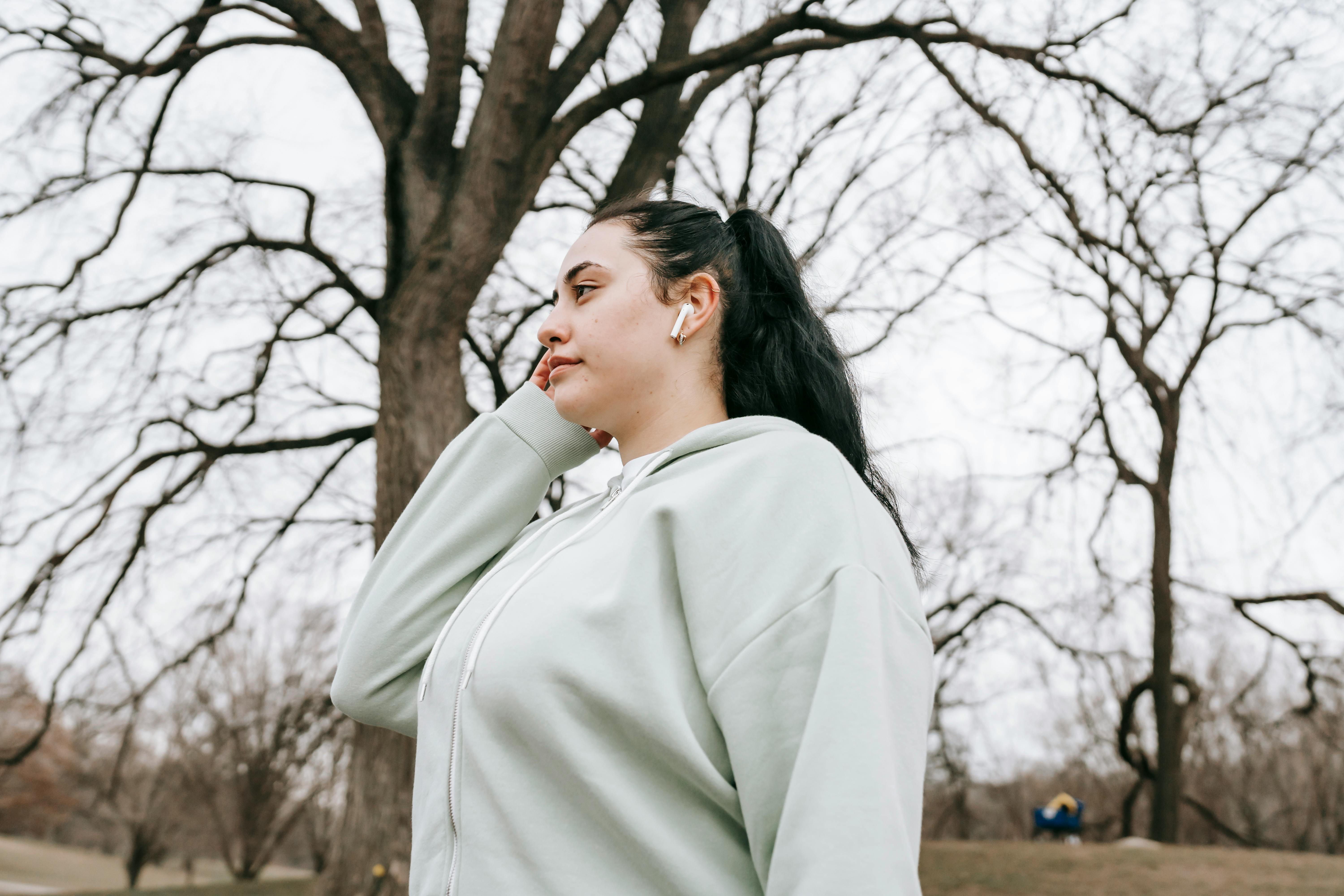 Young overweight woman with wireless earphones · Free Stock Photo