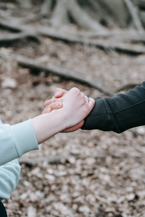 girl and boy holding hands in rain