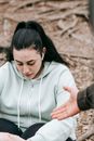 Tired plus sized female sitting on ground and looking down
