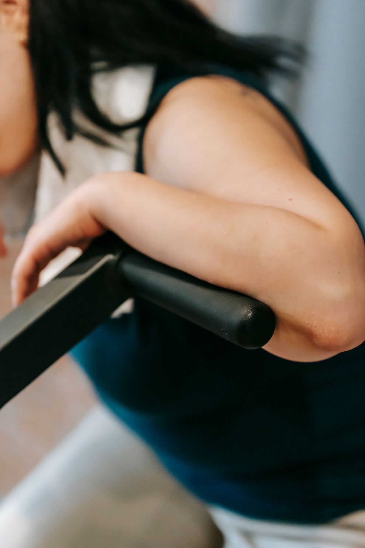 Tired woman resting on an exercise bike after a workout
