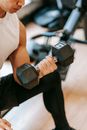 Fit man doing exercises with dumbbell
