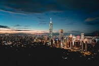 Cityscape with modern illuminated skyscrapers and buildings in evening