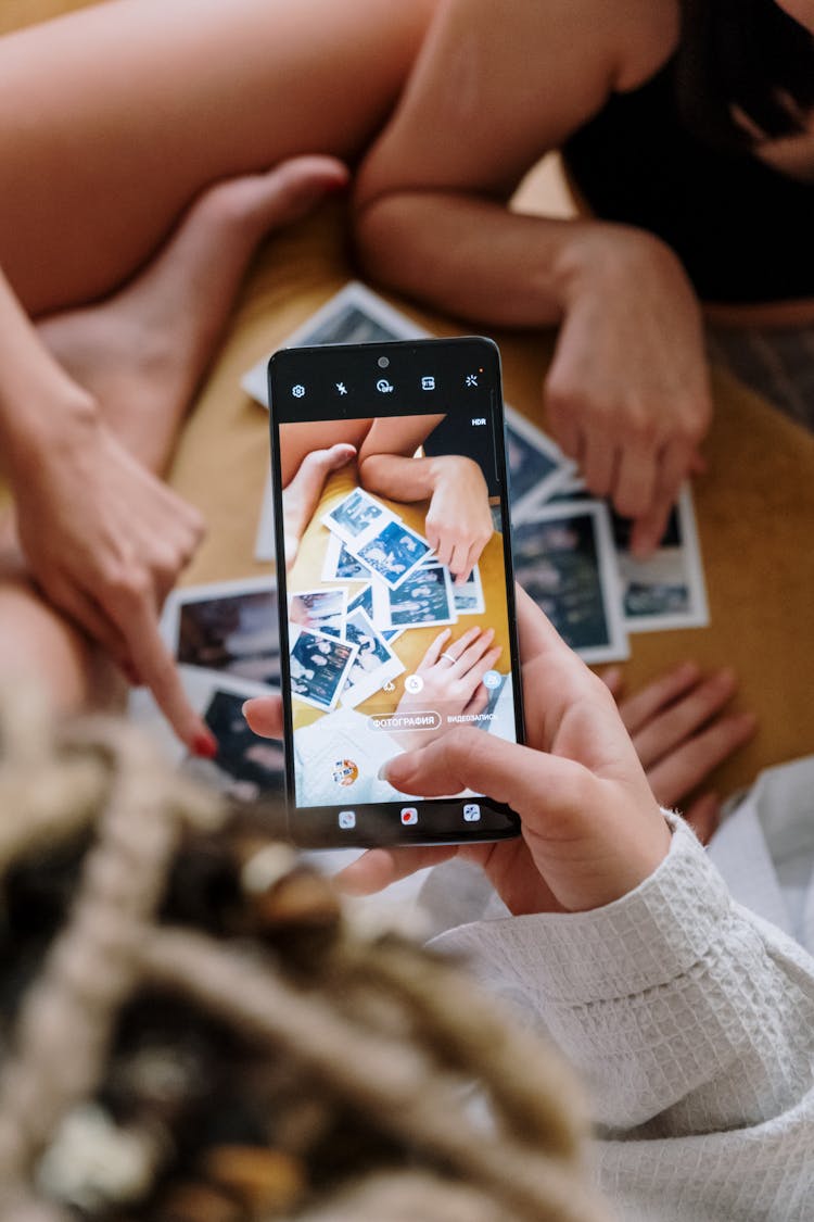 Women In Pajamas Holding Polaroid Pictures