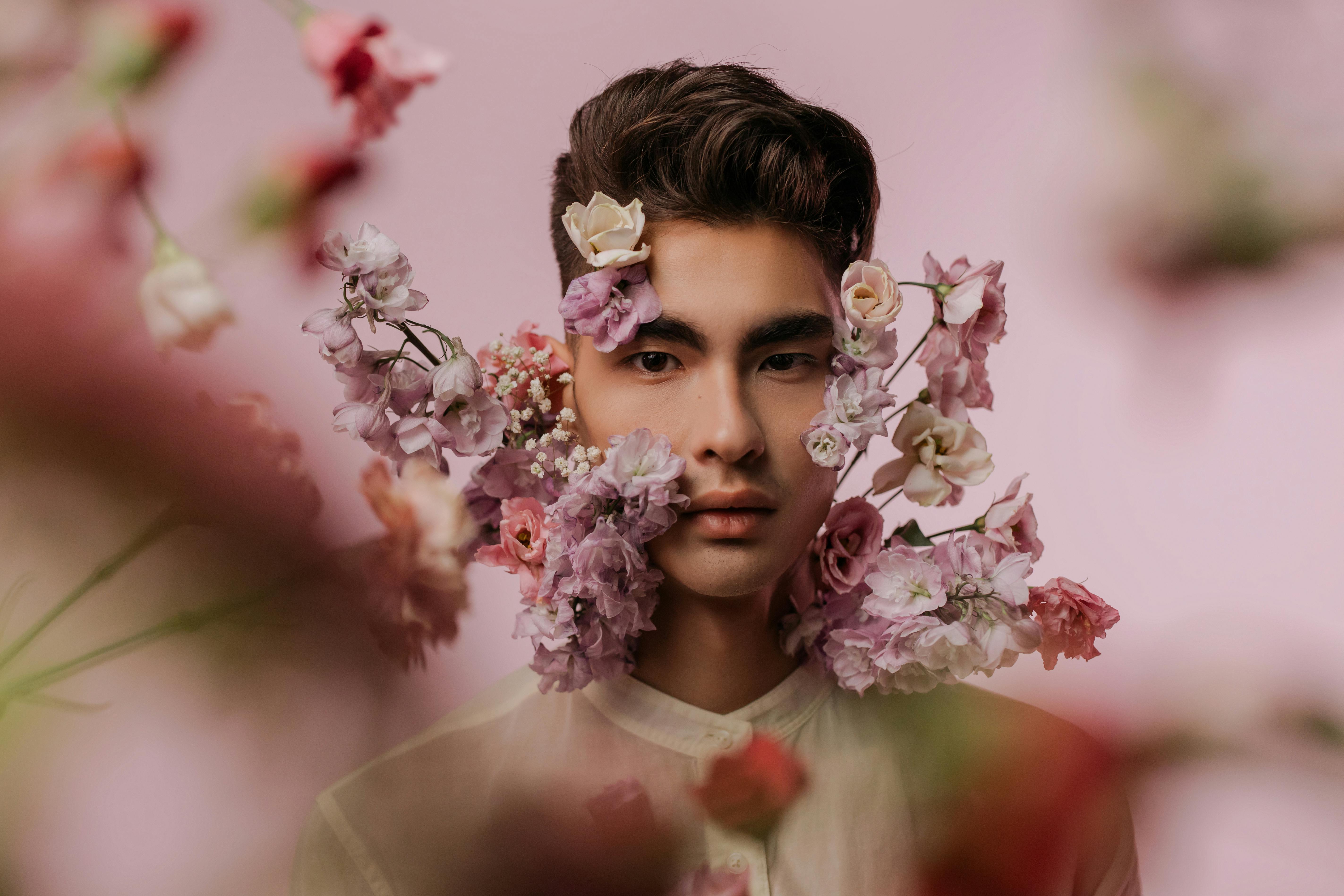 Download Man's Face With Pink Flowers Aesthetic Wallpaper