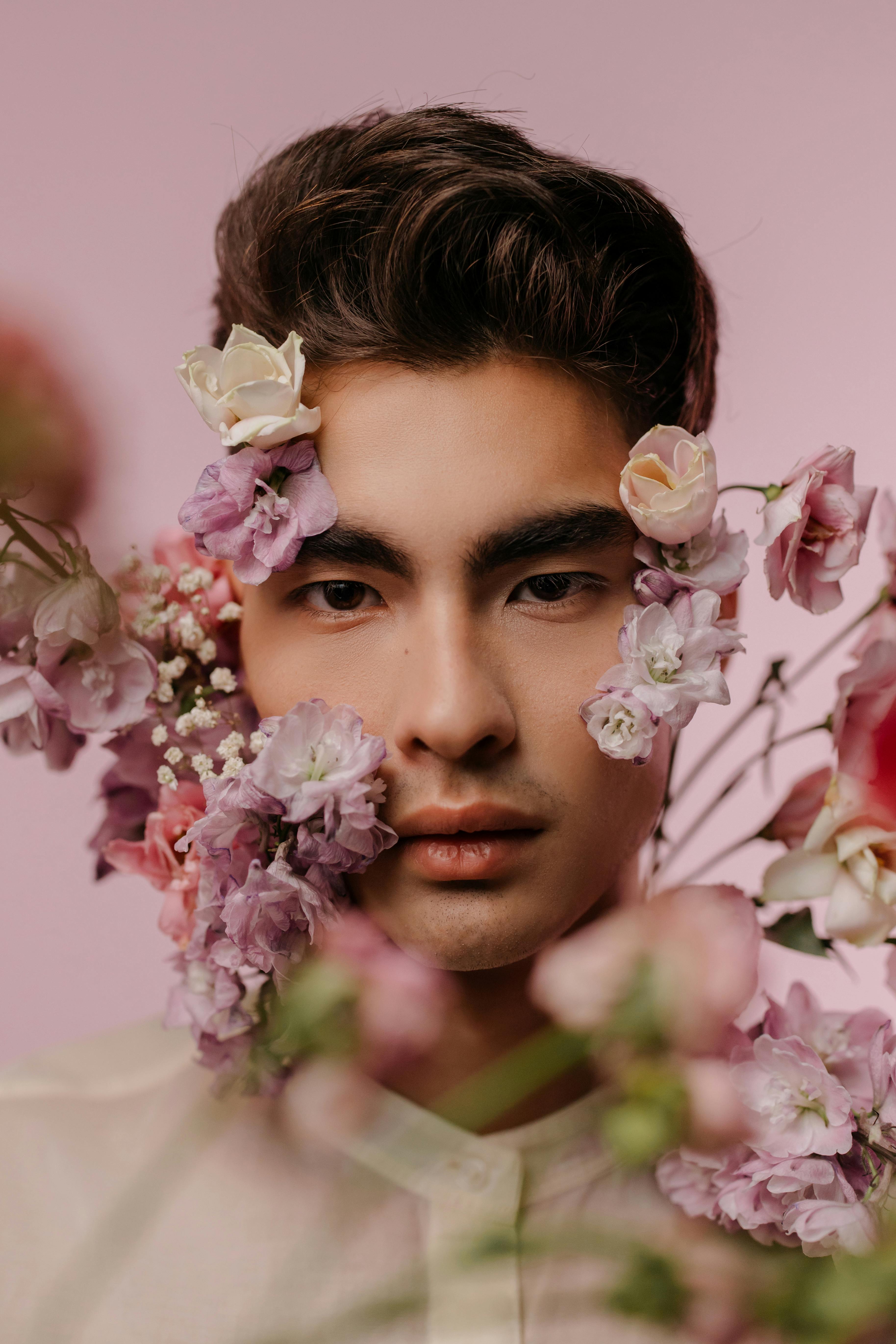 Download Man's Face With Pink Flowers Aesthetic Wallpaper